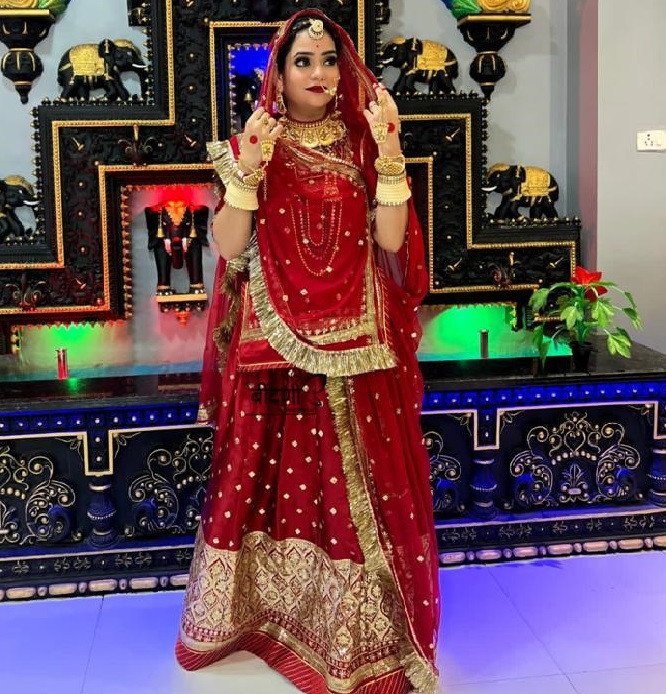 Royal Crimson: The Silk Satin Red Poshak Adorned with Golden Sequins(semi stich)